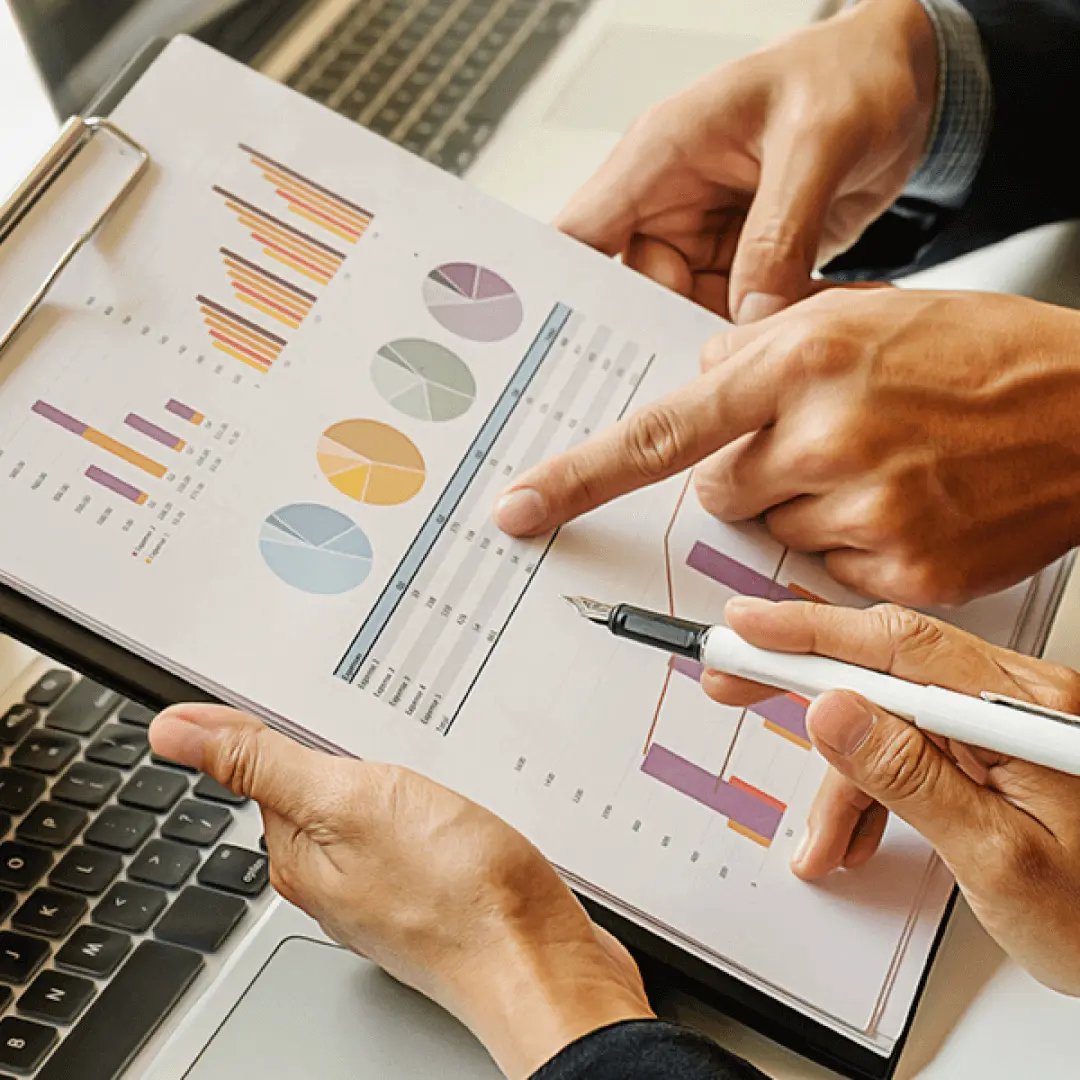 Close up of hands reviewing financial charts & graphs indicating meticulous accounting services