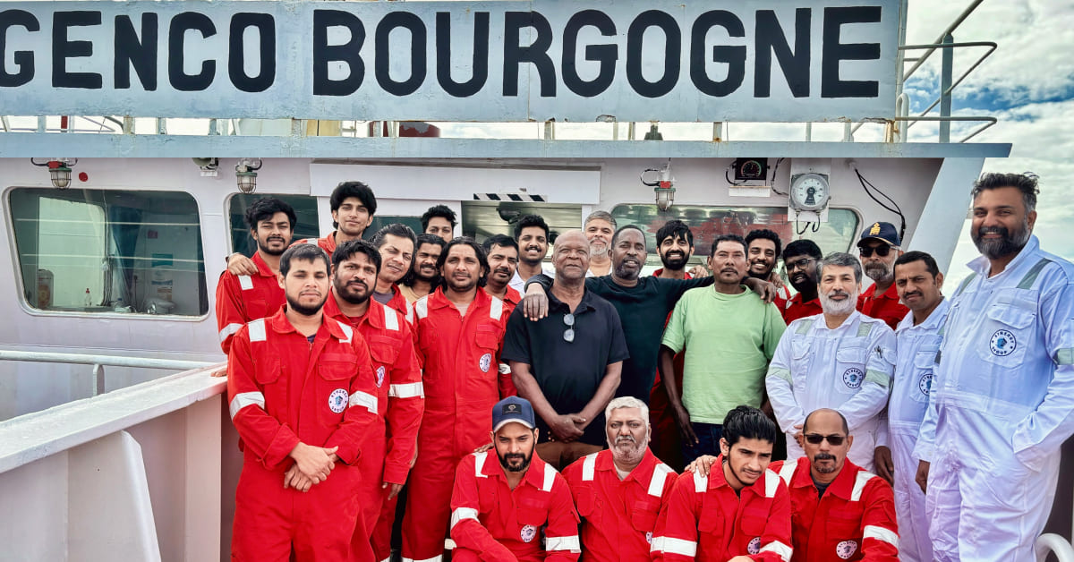 Crew of Genco Bourgogne standing with the rescued individuals, smiling together for a group photo.