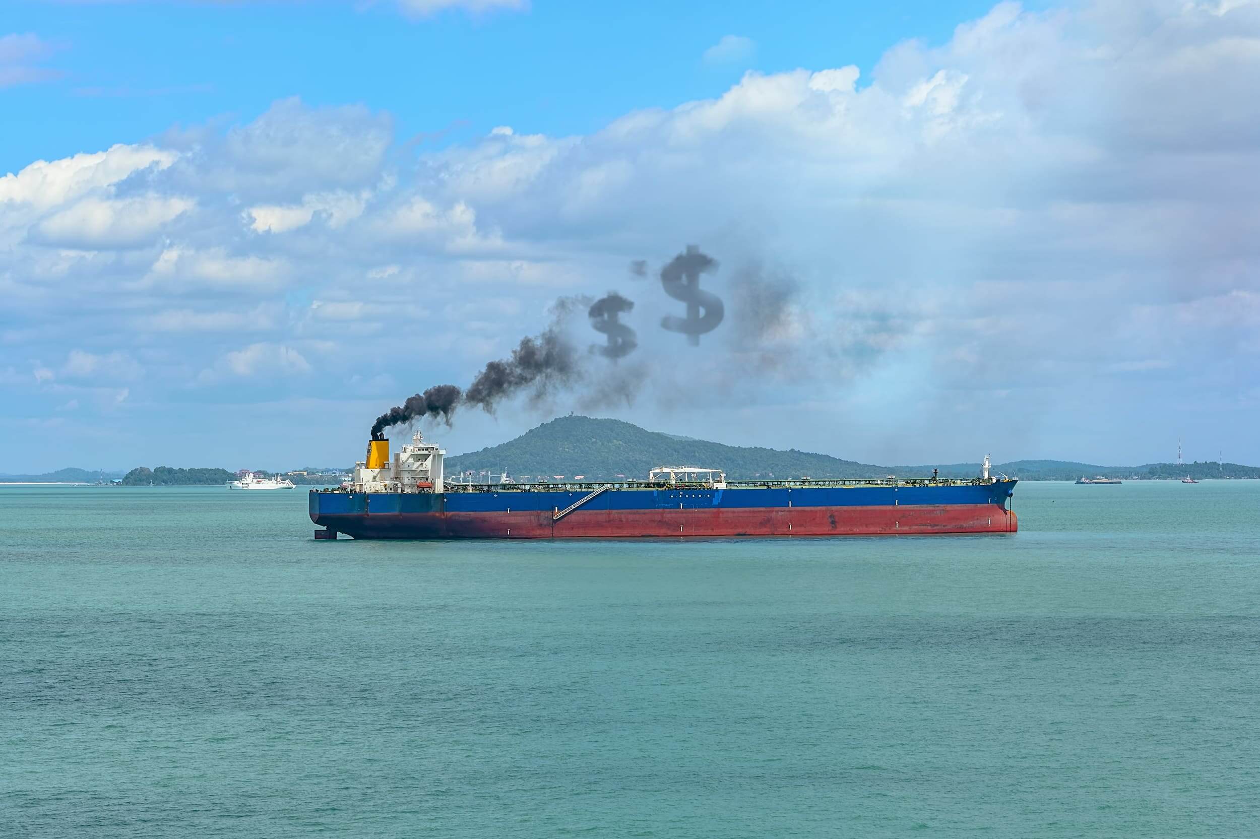 Large cargo ship at sea with smoke rising from its funnel in the shape of dollar signs.