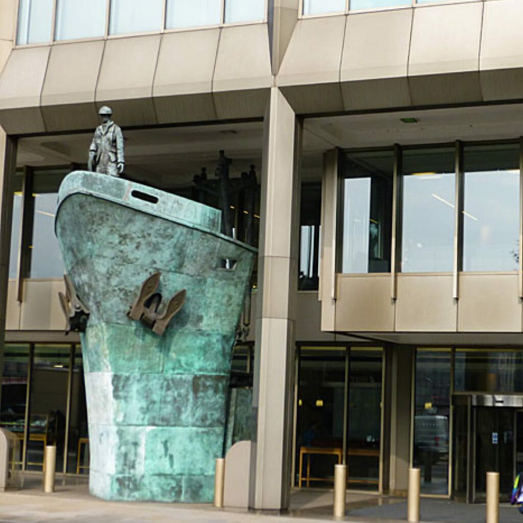 Bronze seafarer memorial statue on a ship's bow outside the International Maritime Organization (IMO) building headquarters in London