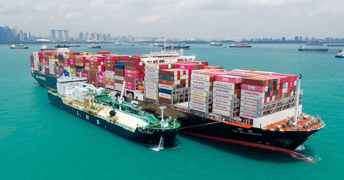 Aerial view of the Yang Ming container ship YM Willpower navigating the open blue sea.