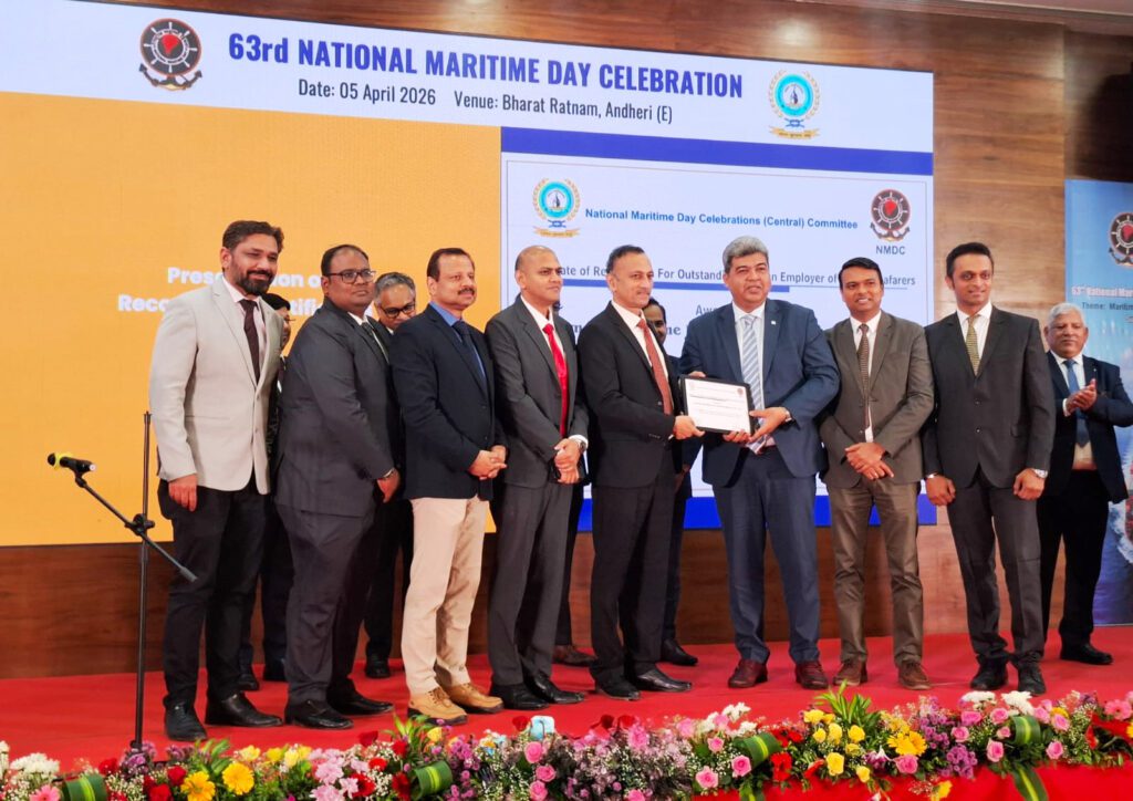 Maneesh Pradhan, Managing Director – Global Marine HR at Synergy Group, accepting the "Outstanding Foreign Employer of Indian Seafarers" award at the 63rd National Maritime Day Celebration in Mumbai, April 2026. A group of maritime leaders stands on stage against a backdrop highlighting the event theme.