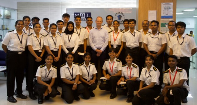 Synergy Group maritime cadets in uniform posing for a group photo with Jesper Kristensen, Group CEO, Synergy Marine Group.