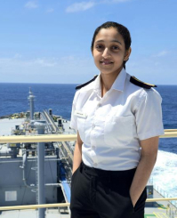 Portrait of Hifa Salim, 5th Engineer for Synergy Marine Group, standing on the deck of the vessel BW Kizoku with the ocean in the background.
