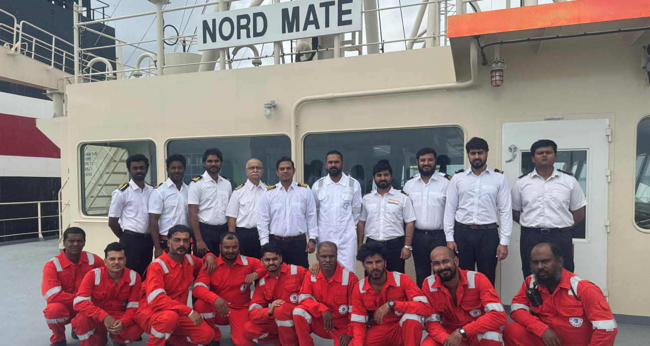 The crew and officers of the vessel Nord Mate standing together on the ship deck for a group portrait.