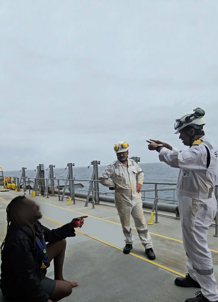 GLOBE POLARIS officers speaking with the rescued sailor after he was safely brought aboard following a rescue at sea.